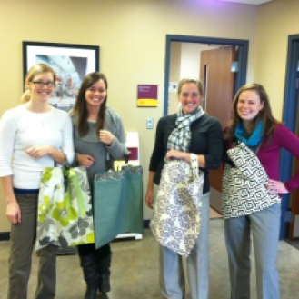 the women of the University of Minnesota's Athletic Department wearing their DIY tote bags!